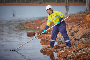 Newmont environment personnel taking water sample 